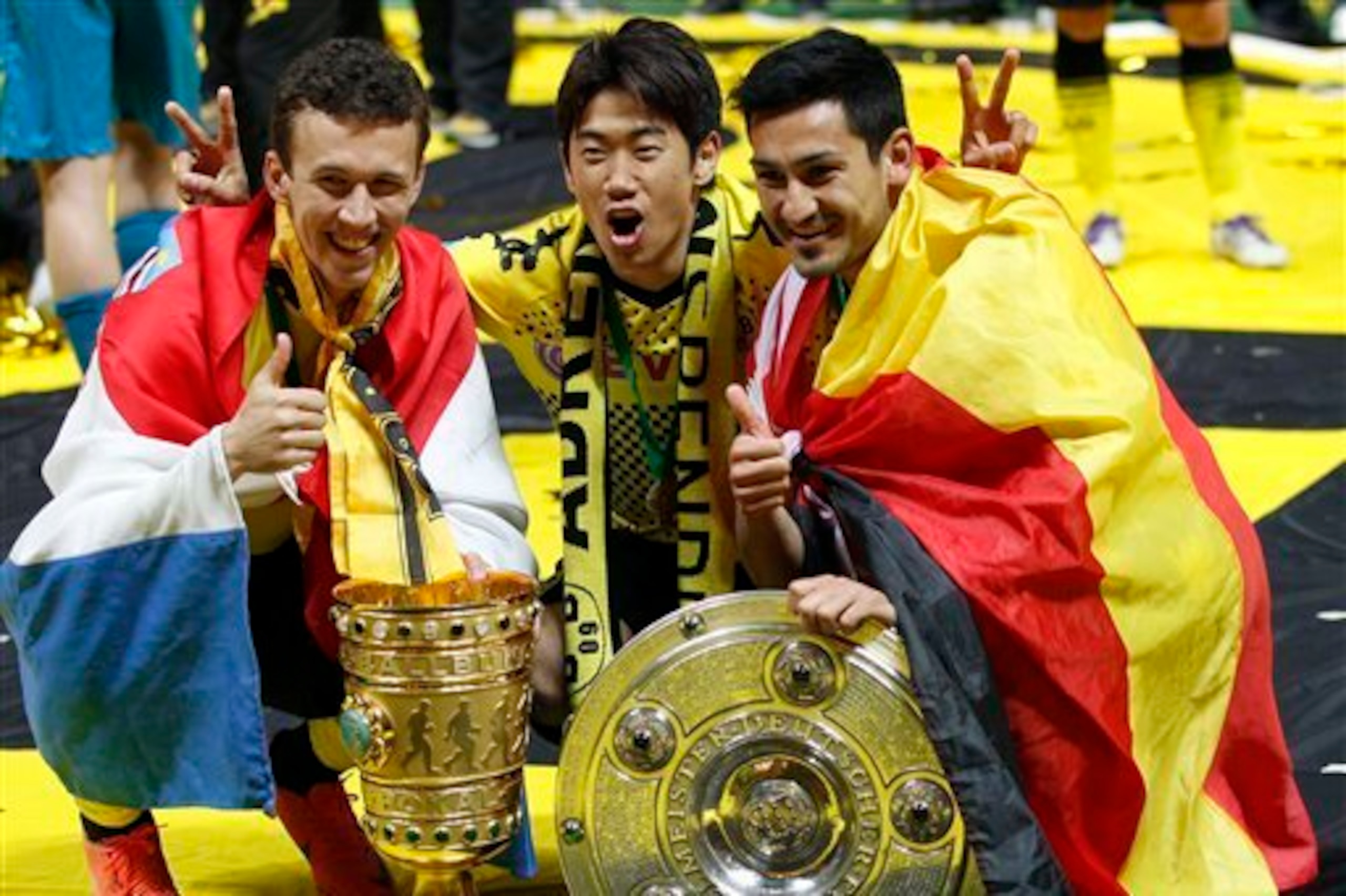 Ivan Perisic, Shinji Kagawa and Ilkay Gundogan celebrating Dortmund's last silverware in 2012.
