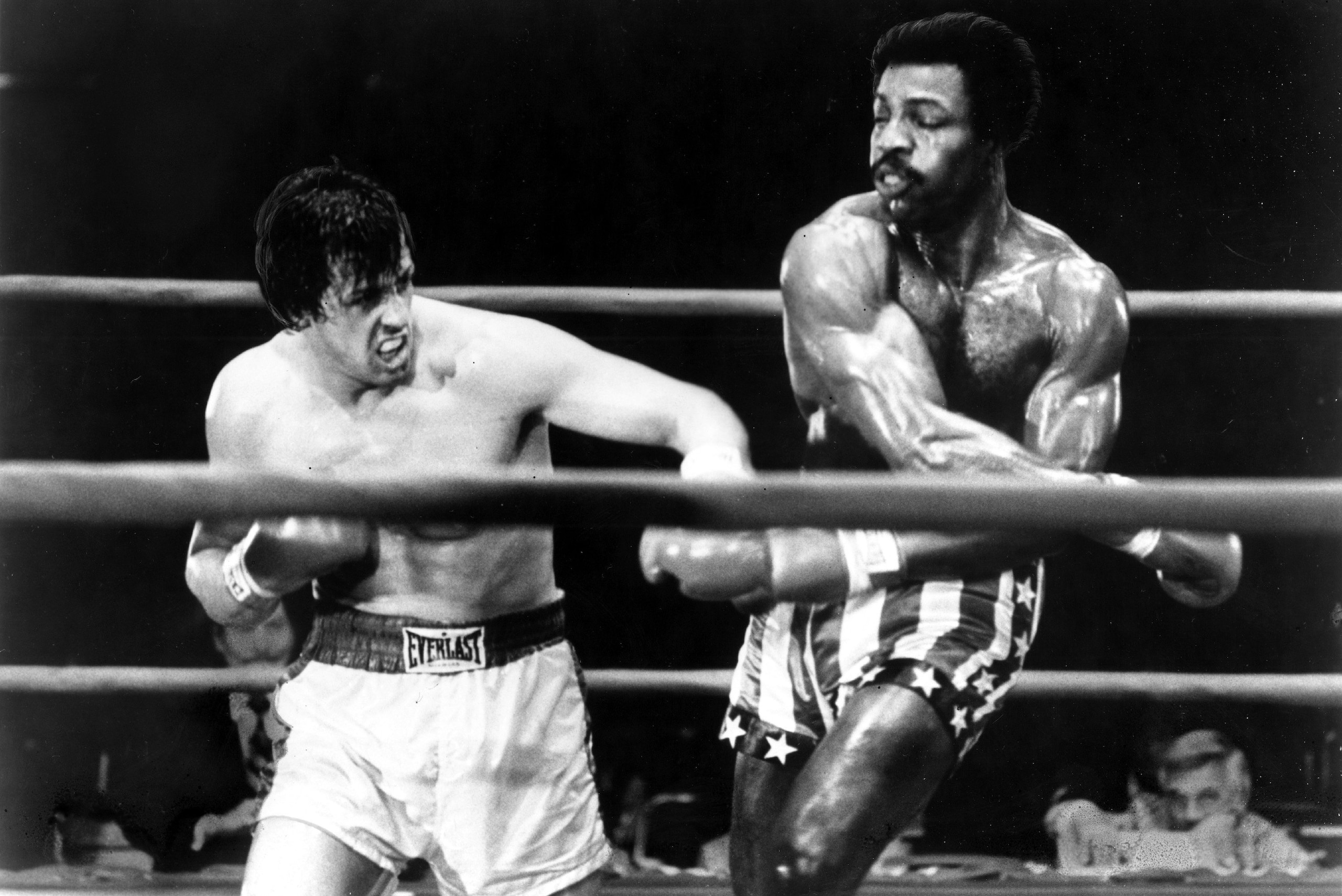Sylvester Stallone and Carl Weathers as Rocky Balboa and Apollo Creed.