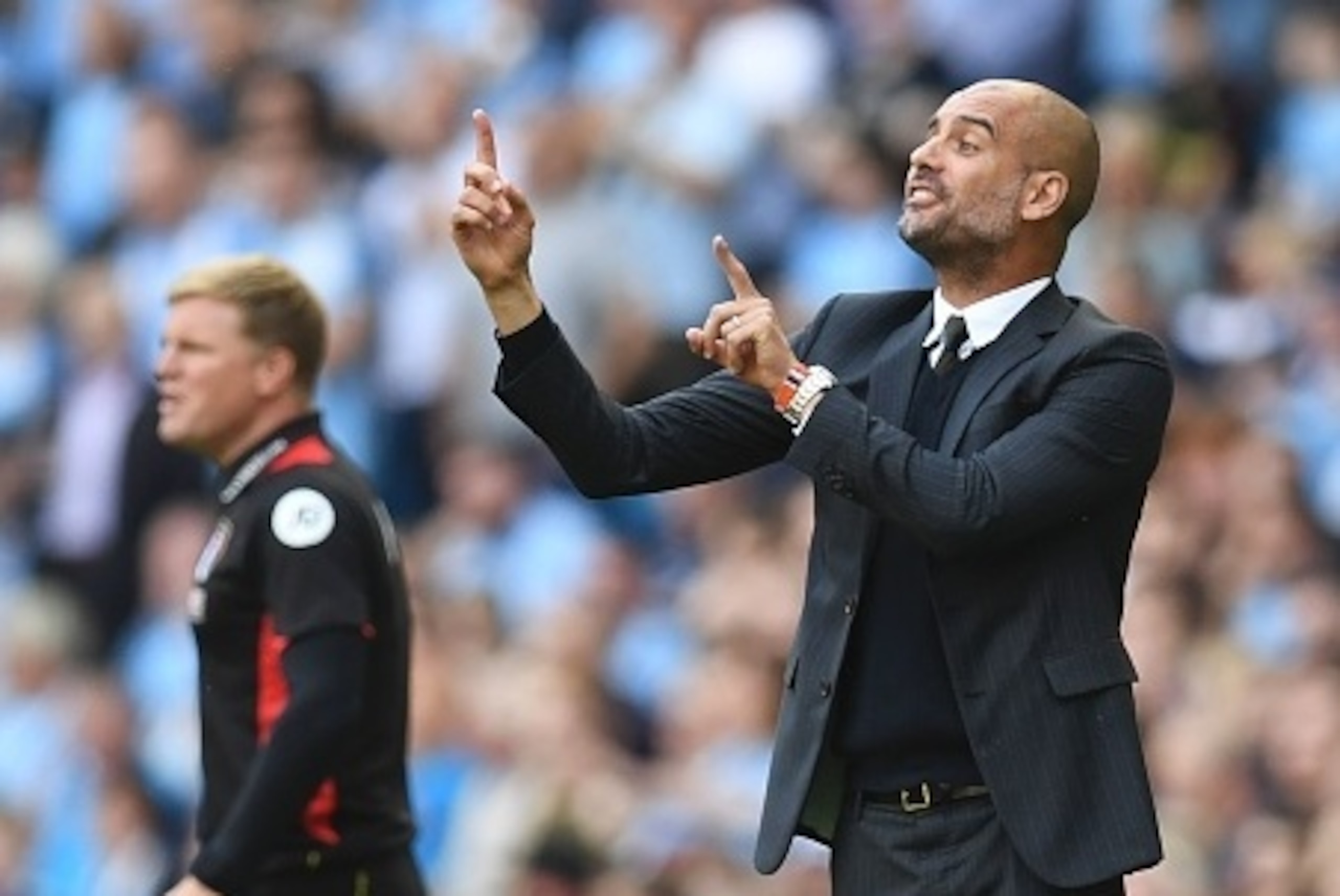 Manchester City's Spanish manager Pep Guardiola (R) gestures on the touchline next to Bournemouth's English manager Eddie Howe (L) during the English Premier League football match between Manchester City and Bournemouth at the Etihad Stadium in Manchester