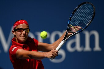 NEW YORK, NY - AUGUST 30:  Kirsten Flipkens of Belgium returns a shot to Simona Halep of Romania during her first round Women's Singles match on Day Two of the 2016 US Open at the USTA Billie Jean King National Tennis Center on August 30, 2016 in the Flus