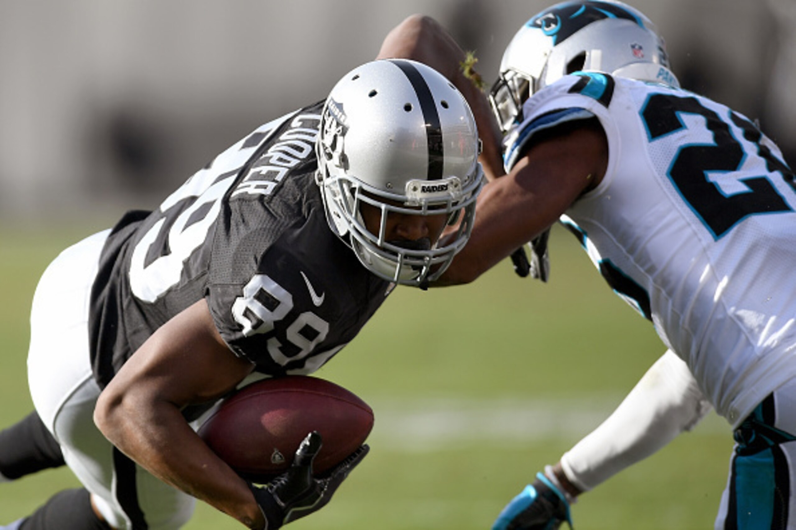 OAKLAND, CA - NOVEMBER 27: Amari Cooper #89 of the Oakland Raiders catches a pass and gets tackled by Daryl Worley #26 of the Carolina Panthers during an NFL football game on November 27, 2016 at the Oakland-Alameda County Coliseum in Oakland, California OAKLAND, CA - NOVEMBER 27: Amari Cooper #89 of the Oakland Raiders catches a pass and gets tackled by Daryl Worley #26 of the Carolina Panthers during an NFL football game on November 27, 2016 at the Oakland-Alameda County Coliseum in Oakland, California