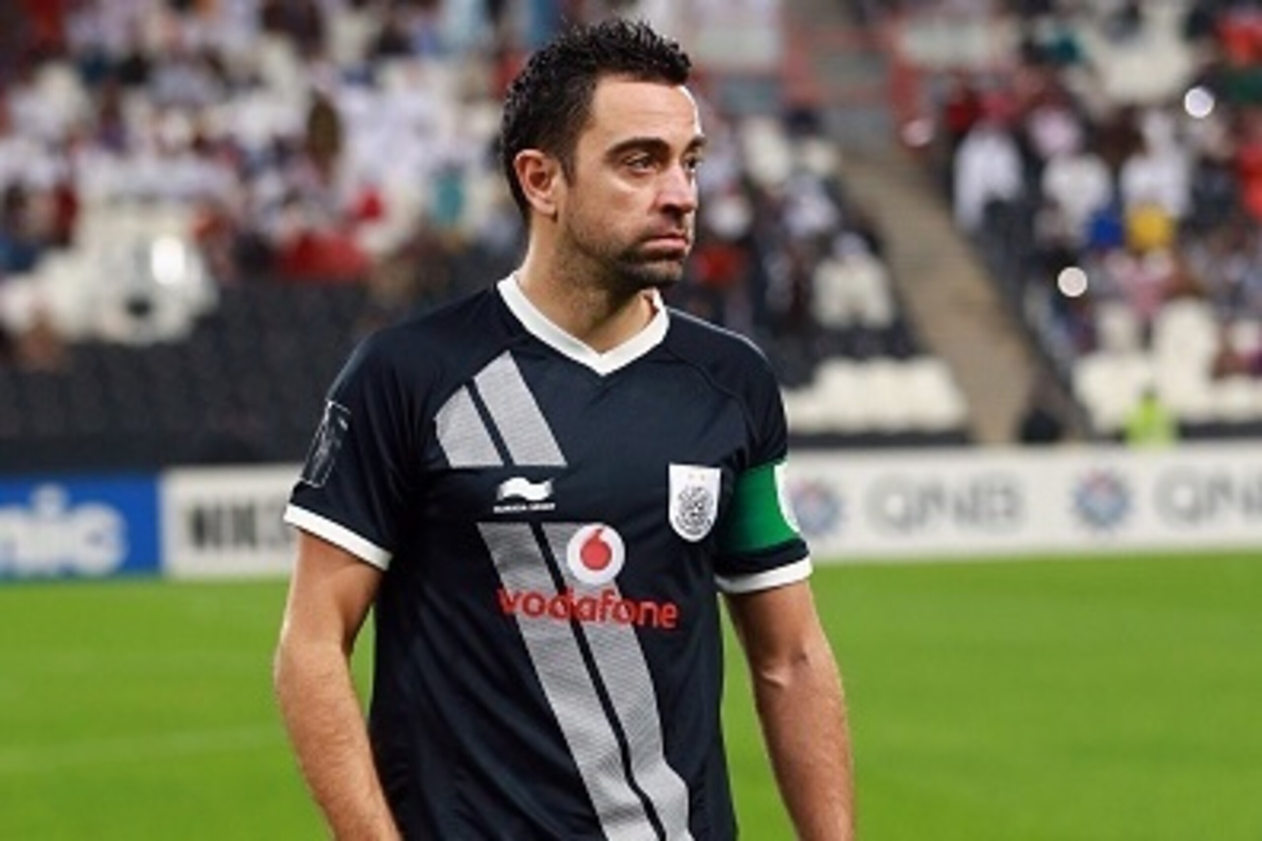 Qatar's Al-Sadd club Spanish player Xavi Hernandez waits for a team photo prior to the start of their AFC Champions League third round qualifying football match against UAE's Al-Jazeera club at the Mohammed Bin Zayed Stadium in Abu Dhabi on February 9, 20 Qatar's Al-Sadd club Spanish player Xavi Hernandez waits for a team photo prior to the start of their AFC Champions League third round qualifying football match against UAE's Al-Jazeera club at the Mohammed Bin Zayed Stadium in Abu Dhabi on February 9, 20