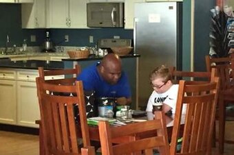 Gary Goodridge spends time with a child on his charity tour