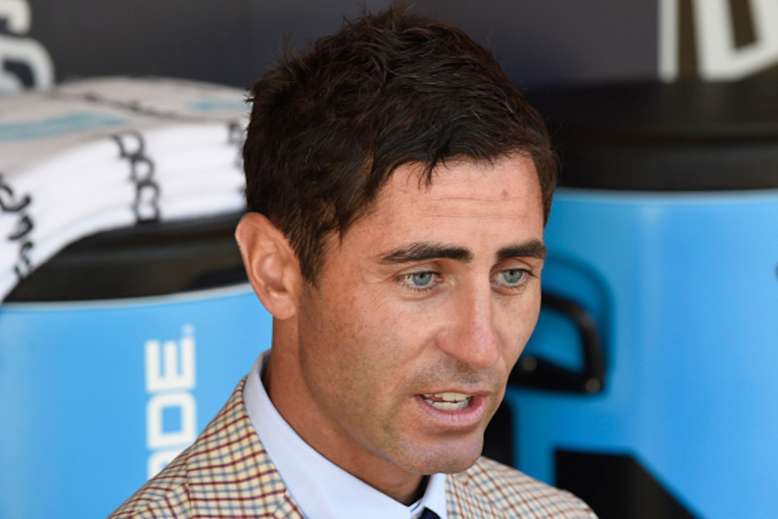 SAN DIEGO, CALIFORNIA - APRIL 04:  San Diego Padres general manager A.J. Preller answers questions in the dugout during batting practice before a baseball game against the Los Angeles Dodgers on opening day at PETCO Park on April 4, 2016 in San Diego, Cal
