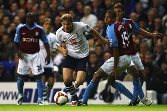 LONDON - SEPTEMBER 15:  Roman Pavlyuchenko of Tottenham gets past Curtis Davies of Aston Villa during the Barclays Premier League match between Tottenham Hotspur and Aston Villa at White Hart Lane on September 19, 2008 in London, England.  (Photo by Mike 