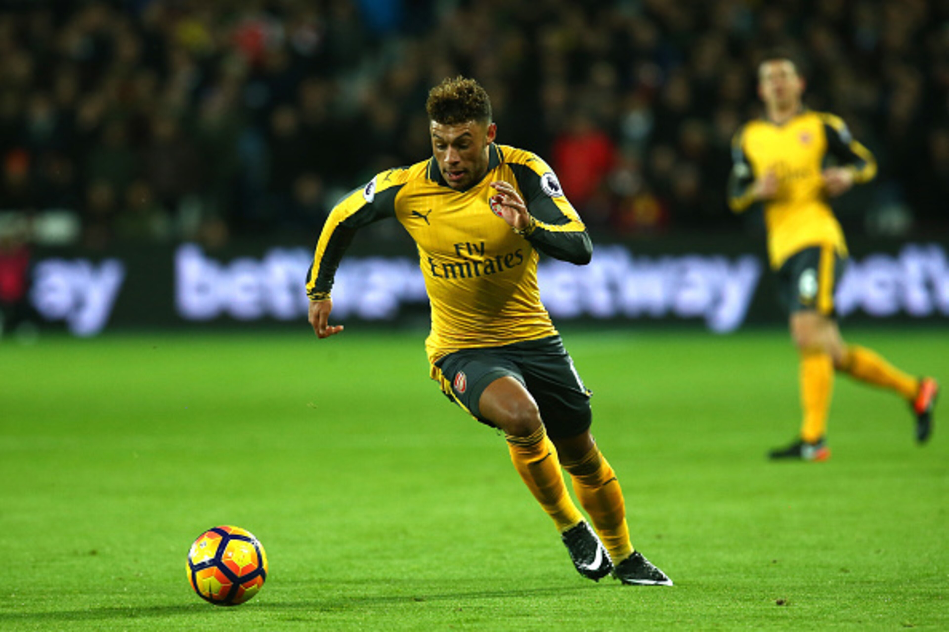 LONDON, ENGLAND - DECEMBER 03:  Alex Oxlade-Chamberlain of Arsenal runs with the ball during the Premier League match between West Ham United and Arsenal at London Stadium on December 3, 2016 in London, England.  (Photo by Charlie Crowhurst/Getty Images)