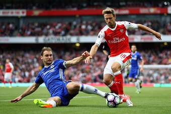 LONDON, ENGLAND - SEPTEMBER 24:  Branislav Ivanovic of Chelsea (L) tackles Nacho Monreal of Arsenal (R) during the Premier League match between Arsenal and Chelsea at the Emirates Stadium on September 24, 2016 in London, England.  (Photo by Paul Gilham/Ge