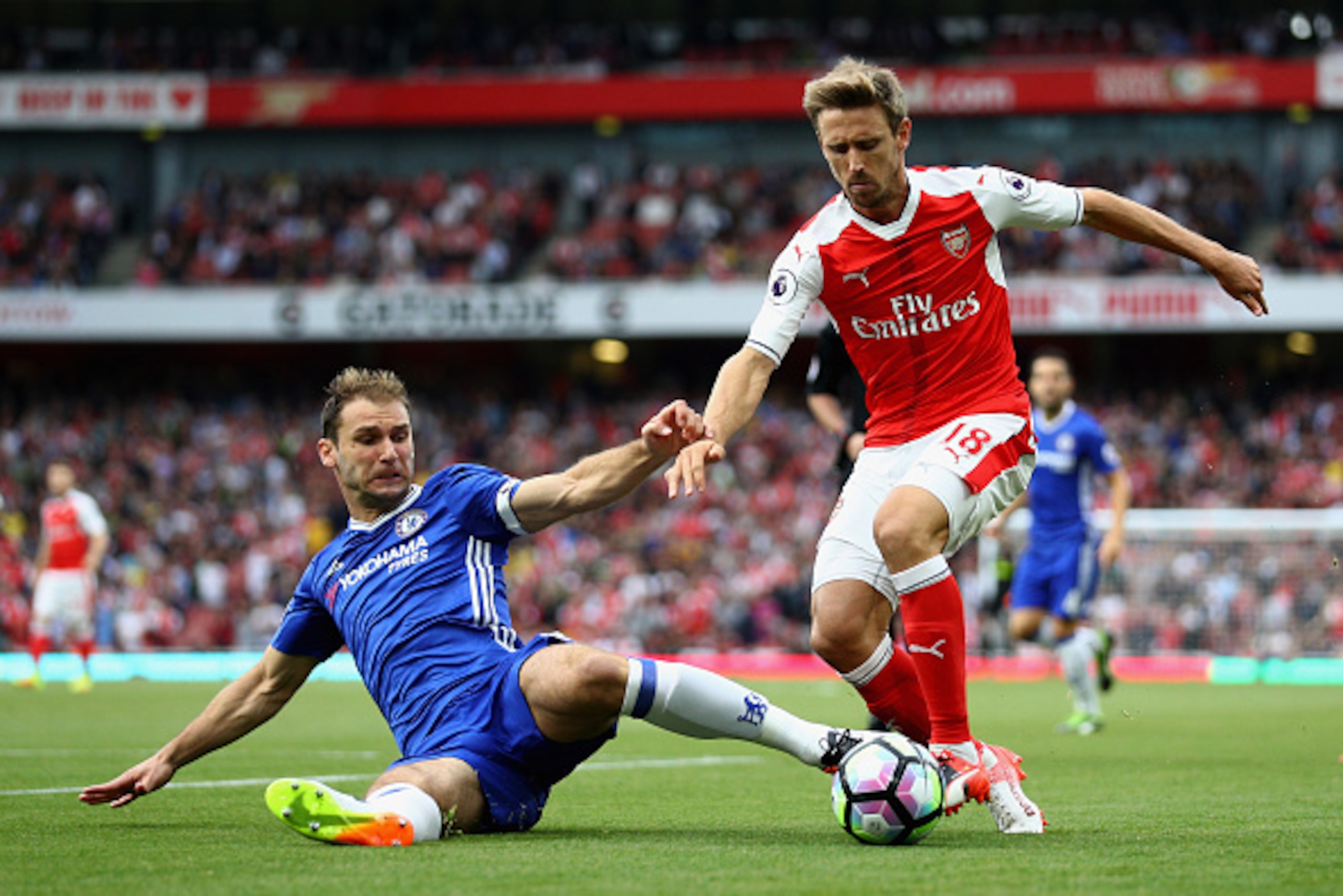 LONDON, ENGLAND - SEPTEMBER 24:  Branislav Ivanovic of Chelsea (L) tackles Nacho Monreal of Arsenal (R) during the Premier League match between Arsenal and Chelsea at the Emirates Stadium on September 24, 2016 in London, England.  (Photo by Paul Gilham/Ge