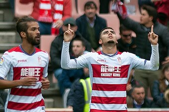 Granada's Belgian midfielder Andreas Pereira (R) celebrates a goal beside Granada's Moroccan midfielder Mehdi Carcela during the Spanish league football match Granada CF vs Sevilla FC at Nuevo Los Carmenes stadium in Granada on December 3, 2016. / AFP / J