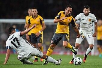 Arsenal's Spanish midfielder Santi Cazorla (2nd R) vies with Basel's Czech defender Marek Suchy during the UEFA Champions League Group A football match between Arsenal and FC Basel at The Emirates Stadium in London on September 28, 2016. / AFP / IKIMAGES 