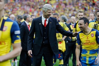 Arsene Wenger jokes with Santi Cazorla after the match during the F.A. Cup Final 2015 Aston Villa v Arsenal at Wembley Stadium on May 30th 2015 in London (Photo by Tom Jenkins/Getty Images)