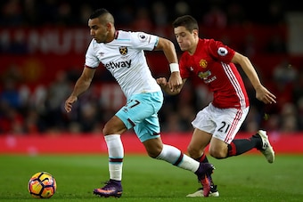 MANCHESTER, ENGLAND - NOVEMBER 27: Dimitri Payet of West Ham United (L) takes the ball past Ander Herrera of Manchester United (R) during the Premier League match between Manchester United and West Ham United at Old Trafford on November 27, 2016 in Manche