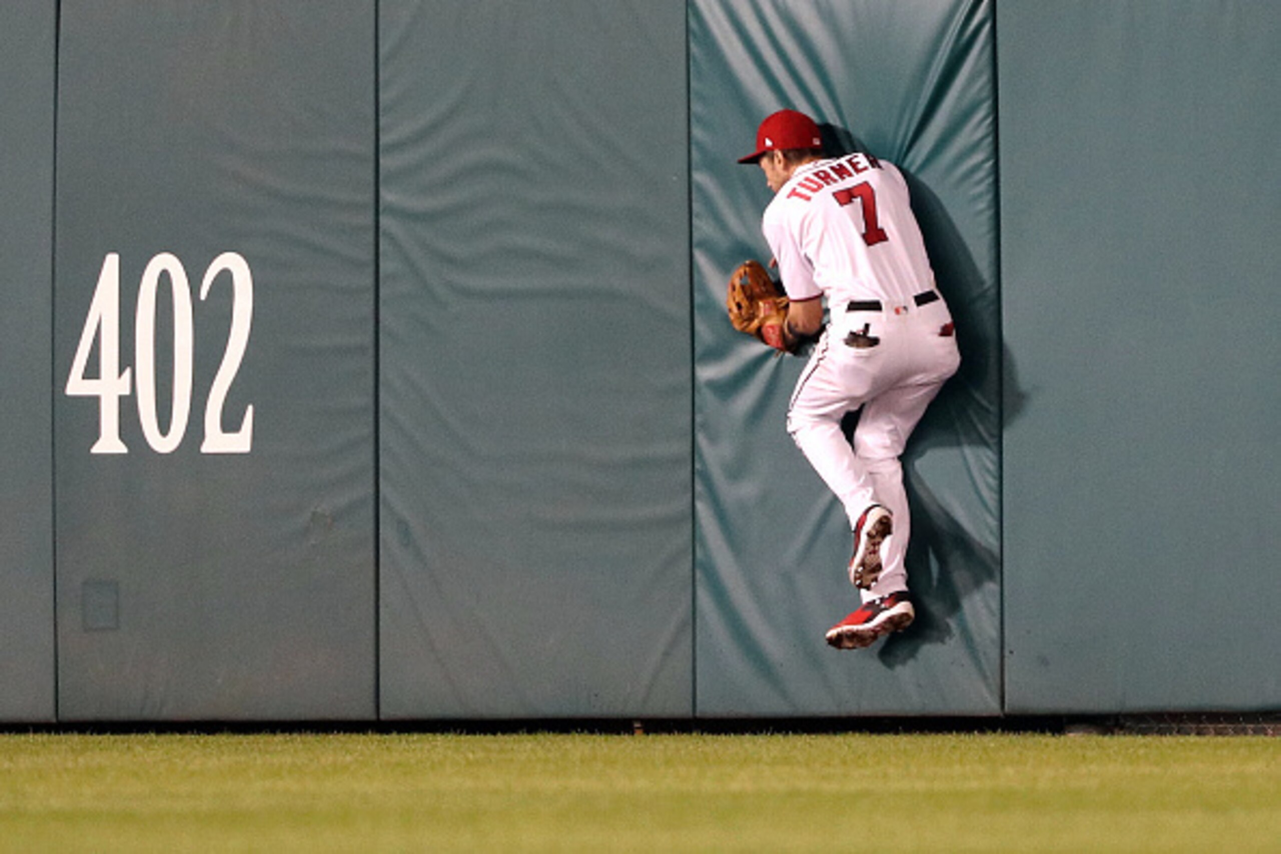 WASHINGTON, DC - OCTOBER 13: Trea Turner #7 of the Washington Nationals misses a play on a two run RBI triple hit by Justin Turner #10 of the Los Angeles Dodgers (not pictured) in the seventh inning during game five of the National League Division Series 