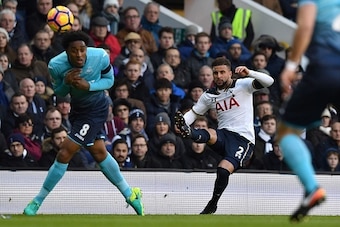 Tottenham Hotspur's English defender Kyle Walker (R) crosses the ball past Swansea City's Dutch midfielder Leroy Fer (L) during the English Premier League football match between Tottenham Hotspur and Swansea City at White Hart Lane in London, on December 