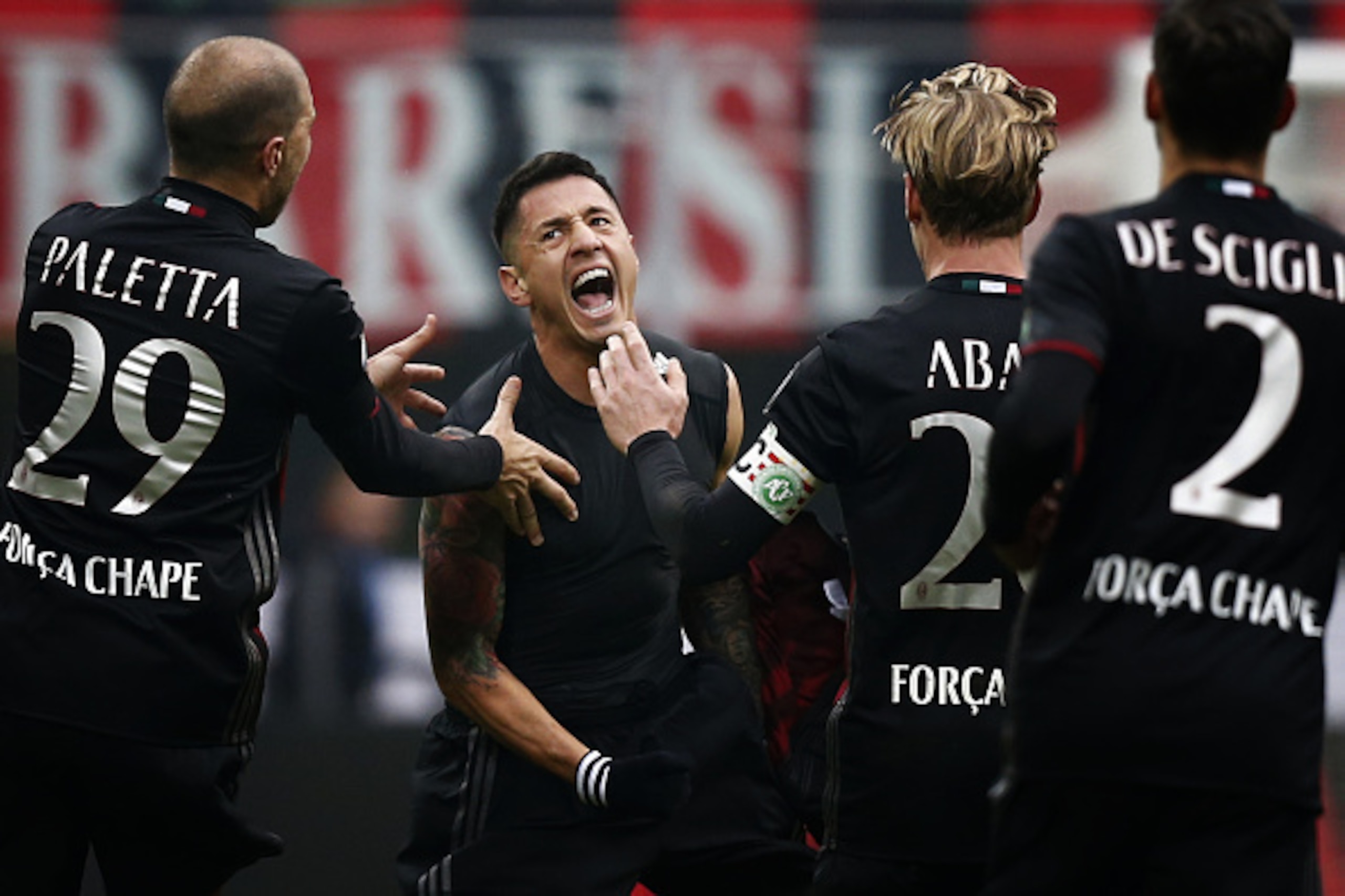 AC Milan's forward Giacomo Lapadula (C) celebrates with teammates after scoring during the Italian Serie A football match AC Milan Vs Crotone on December 4, 2016 at the 'San Siro Stadium' in Milan.  / AFP / MARCO BERTORELLO        (Photo credit should rea