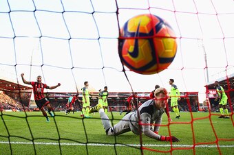 BOURNEMOUTH, ENGLAND - DECEMBER 04:  Loris Karius of Liverpool looks dejected as Callum Wilson of AFC Bournemouth celebrates as Steve Cook of AFC Bournemouthscores their third goal during the Premier League match between AFC Bournemouth and Liverpool at V