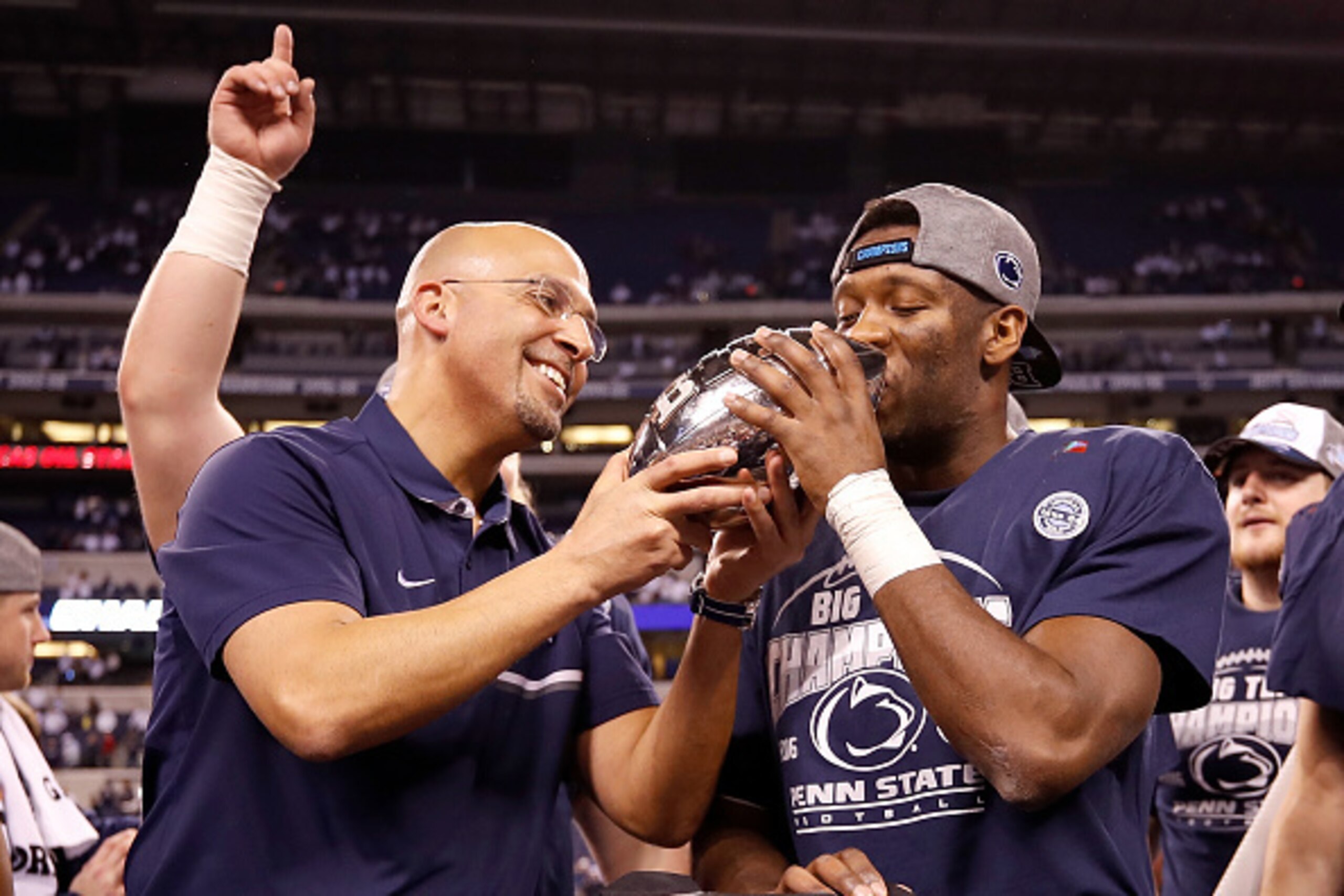 INDIANAPOLIS, IN - DECEMBER 03: James Franklin, head coach of the Penn State Nittany Lions, and Malik Golden #6 of the Penn State Nittany Lions celebrate with the Big Ten Championship Trophy at Lucas Oil Stadium on December 3, 2016 in Indianapolis, Indian