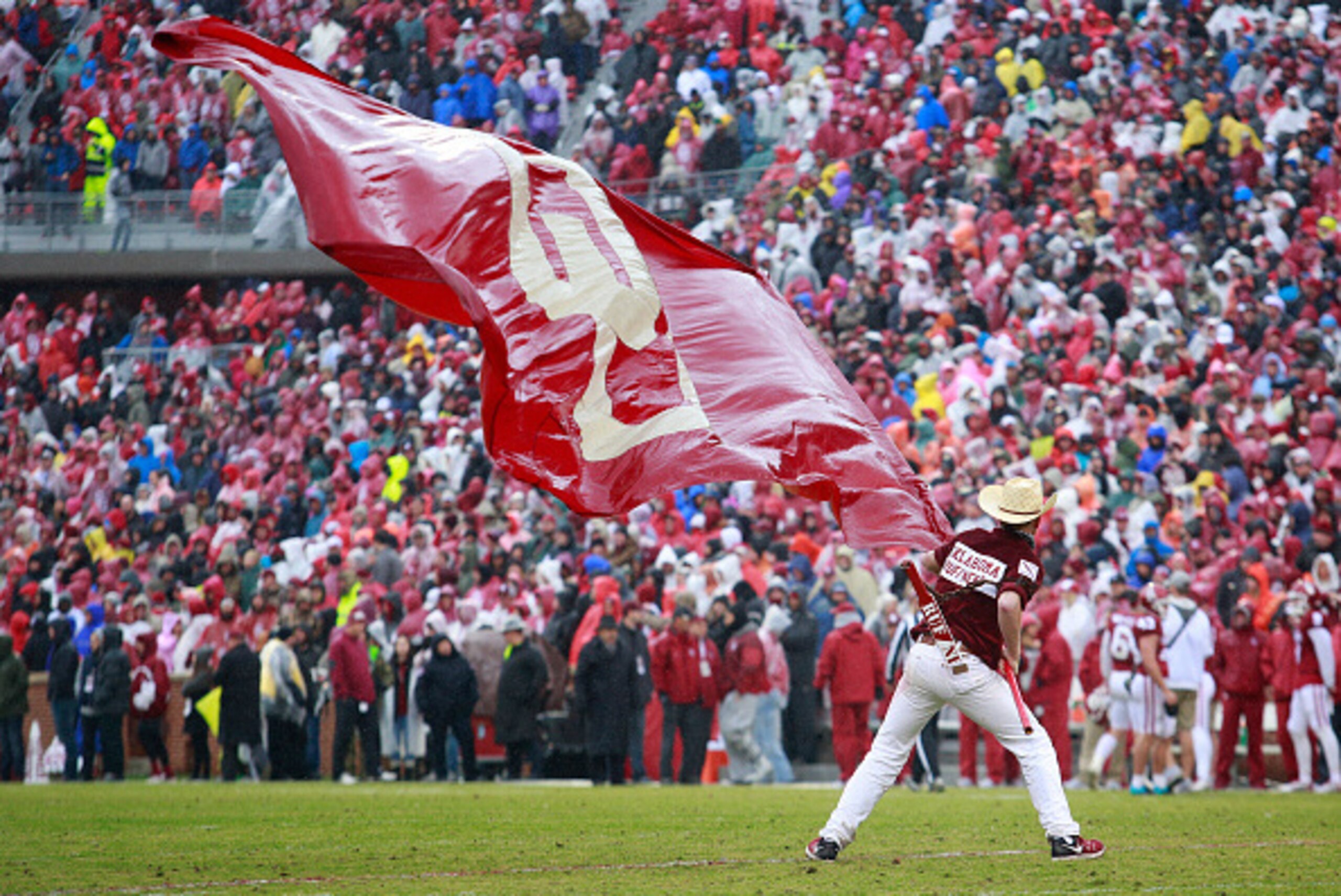 NORMAN, OK - DECEMBER 3:  A member of the Oklahoma Sooners spirit squad waves a wet flag after a touchdown against the Oklahoma State Cowboys December 3, 2016 at Gaylord Family-Oklahoma Memorial Stadium in Norman, Oklahoma. Oklahoma defeated Oklahoma Stat
