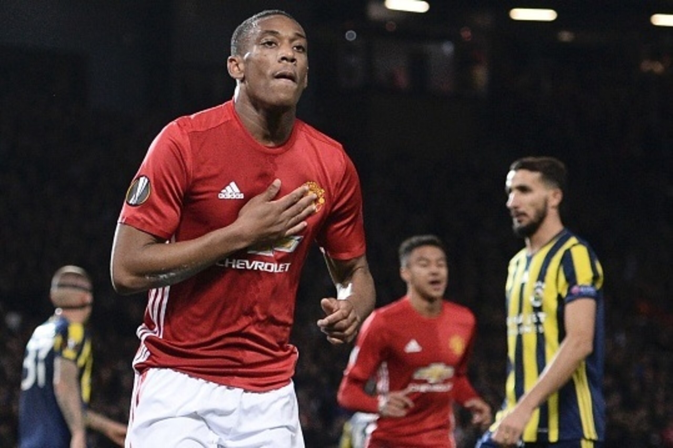 Manchester United's French striker Anthony Martial touches his badge as he celebrates scoring their second goal from the penalty spot during the UEFA Europa League group A football match between Manchester United and Fenerbahce at Old Trafford in Manchest Manchester United's French striker Anthony Martial touches his badge as he celebrates scoring their second goal from the penalty spot during the UEFA Europa League group A football match between Manchester United and Fenerbahce at Old Trafford in Manchest