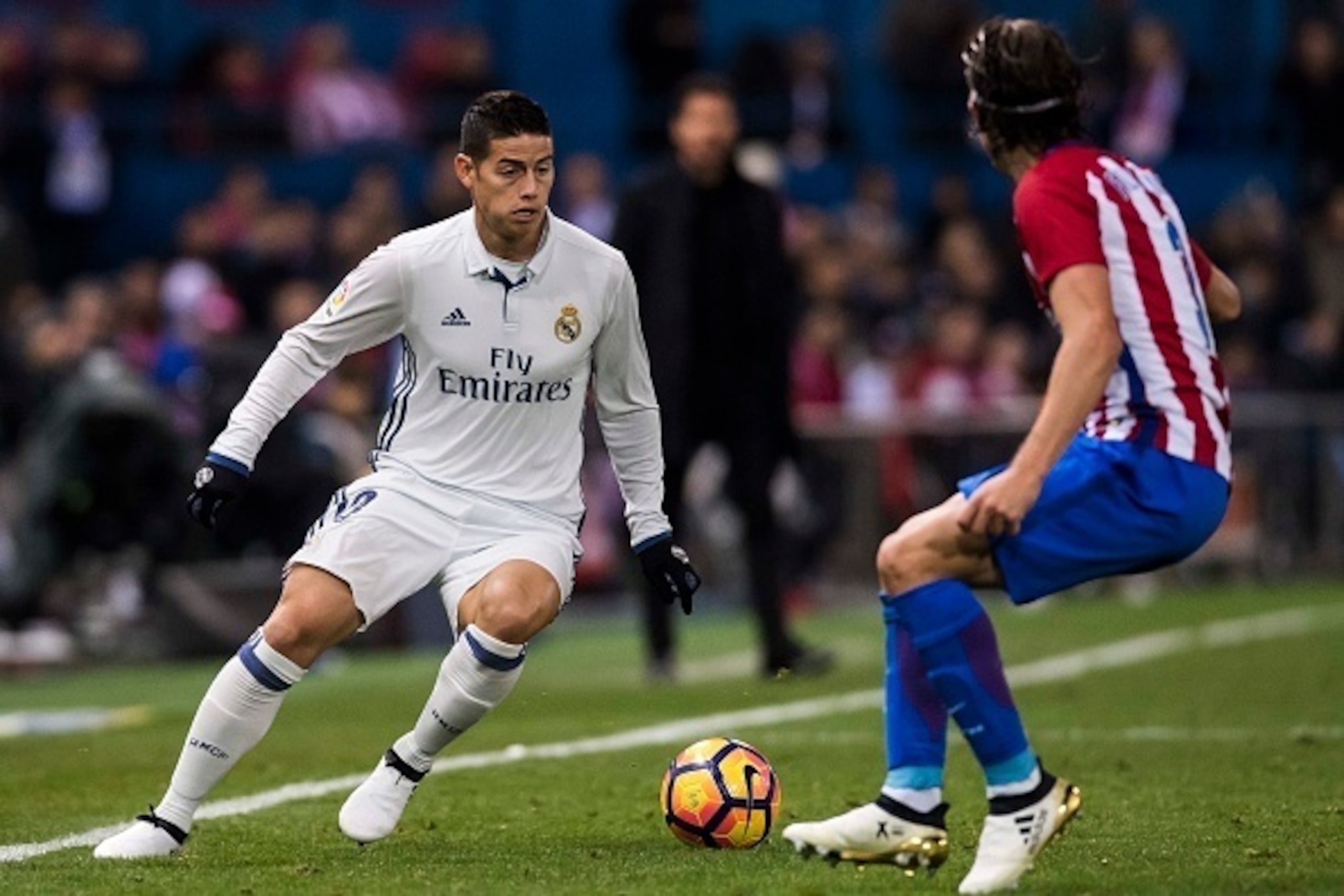 MADRID, SPAIN - NOVEMBER 19: James Rodriguez of Real Madrid fights for the ball with Filipe Luis of Atletico de Madrid during their La Liga match between Atletico de Madrid and Real Madrid at the Vicente Calderon Stadium on 19 November 2016 in Madrid, Sp MADRID, SPAIN - NOVEMBER 19: James Rodriguez of Real Madrid fights for the ball with Filipe Luis of Atletico de Madrid during their La Liga match between Atletico de Madrid and Real Madrid at the Vicente Calderon Stadium on 19 November 2016 in Madrid, Sp