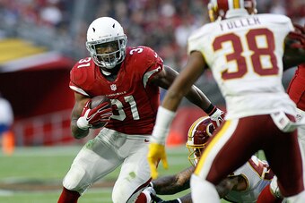 GLENDALE, AZ - DECEMBER 04:  Running back David Johnson #31 of the Arizona Cardinals looks to cut back around Kendall Fuller #38 of the Washington Redskins on a touchdown run during the fourth quarter of a game at University of Phoenix Stadium on December