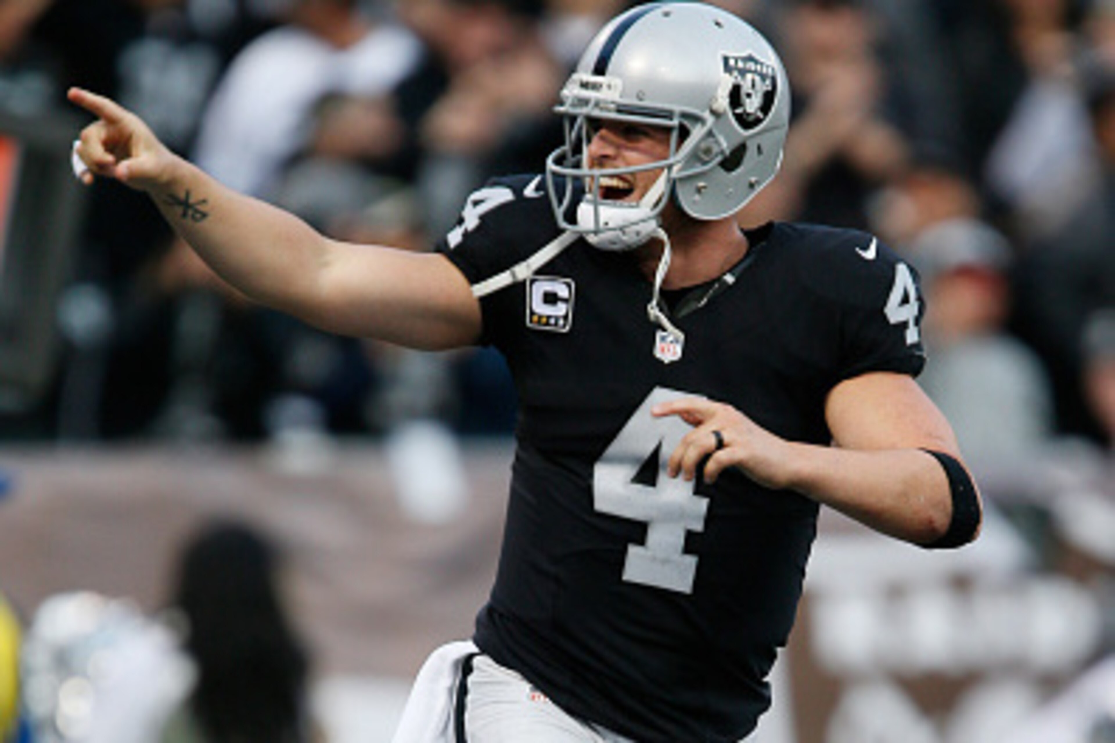 OAKLAND, CA - DECEMBER 04:  Derek Carr #4 of the Oakland Raiders celebrates after a successful two-point conversion against the Buffalo Bills during their NFL game at Oakland Alameda Coliseum on December 4, 2016 in Oakland, California.  (Photo by Brian Ba