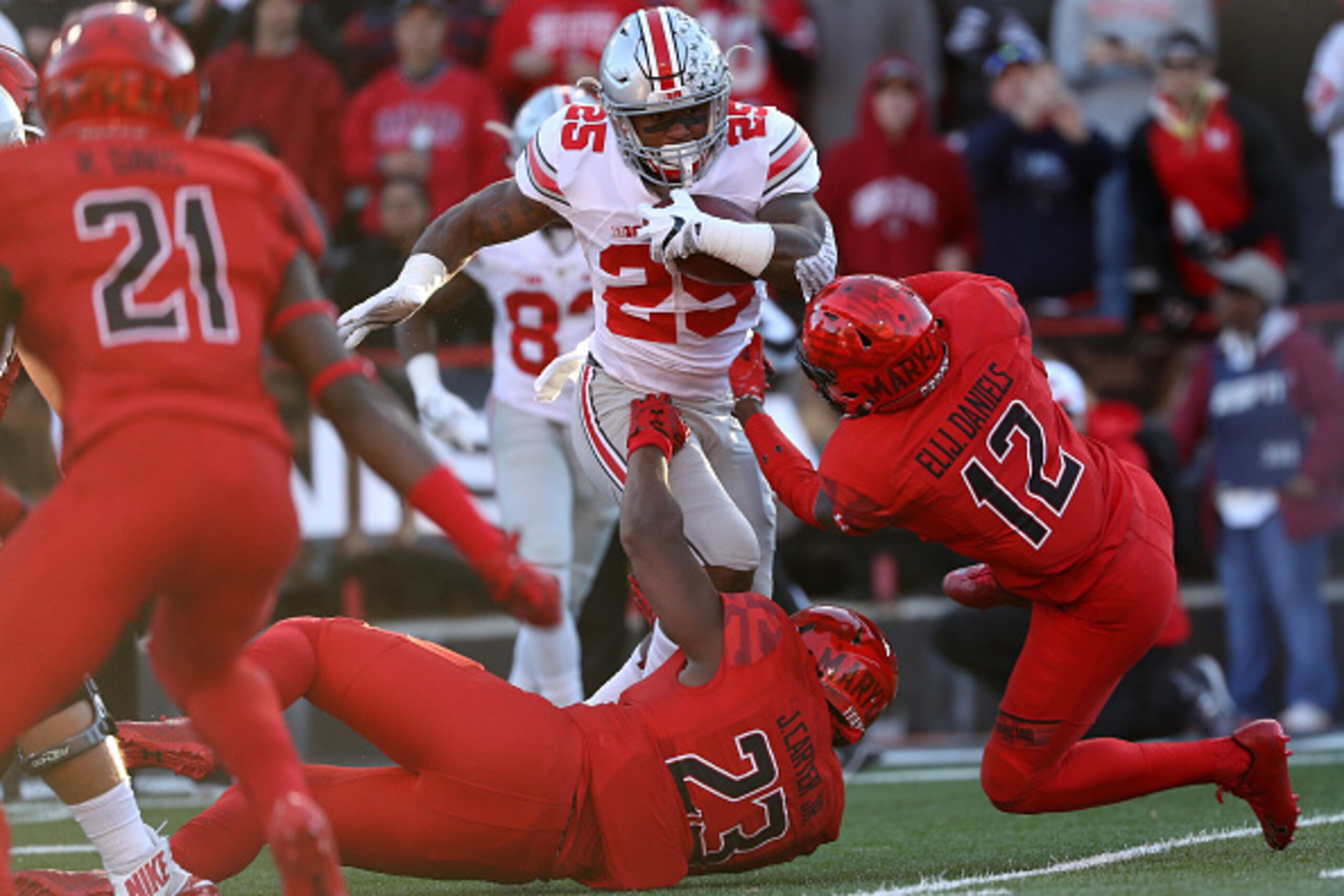 COLLEGE PARK, MD - NOVEMBER 12: Running back Mike Weber #25 of the Ohio State Buckeyes rushes past defensive back Elijah Daniels #12 of the Maryland Terrapins in the first quarter at Capital One Field at Maryland Stadium on November 12, 2016 in College Pa COLLEGE PARK, MD - NOVEMBER 12: Running back Mike Weber #25 of the Ohio State Buckeyes rushes past defensive back Elijah Daniels #12 of the Maryland Terrapins in the first quarter at Capital One Field at Maryland Stadium on November 12, 2016 in College Pa