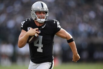 OAKLAND, CA - DECEMBER 04:  Derek Carr #4 of the Oakland Raiders scrambles with the ball against the Buffalo Bills during their NFL game at Oakland Alameda Coliseum on December 4, 2016 in Oakland, California.  (Photo by Thearon W. Henderson/Getty Images)