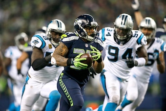 SEATTLE, WA - DECEMBER 04:  Running back Thomas Rawls #34 of the Seattle Seahawks rushes against the Carolina Panthers at CenturyLink Field on December 4, 2016 in Seattle, Washington.  (Photo by Jonathan Ferrey/Getty Images)