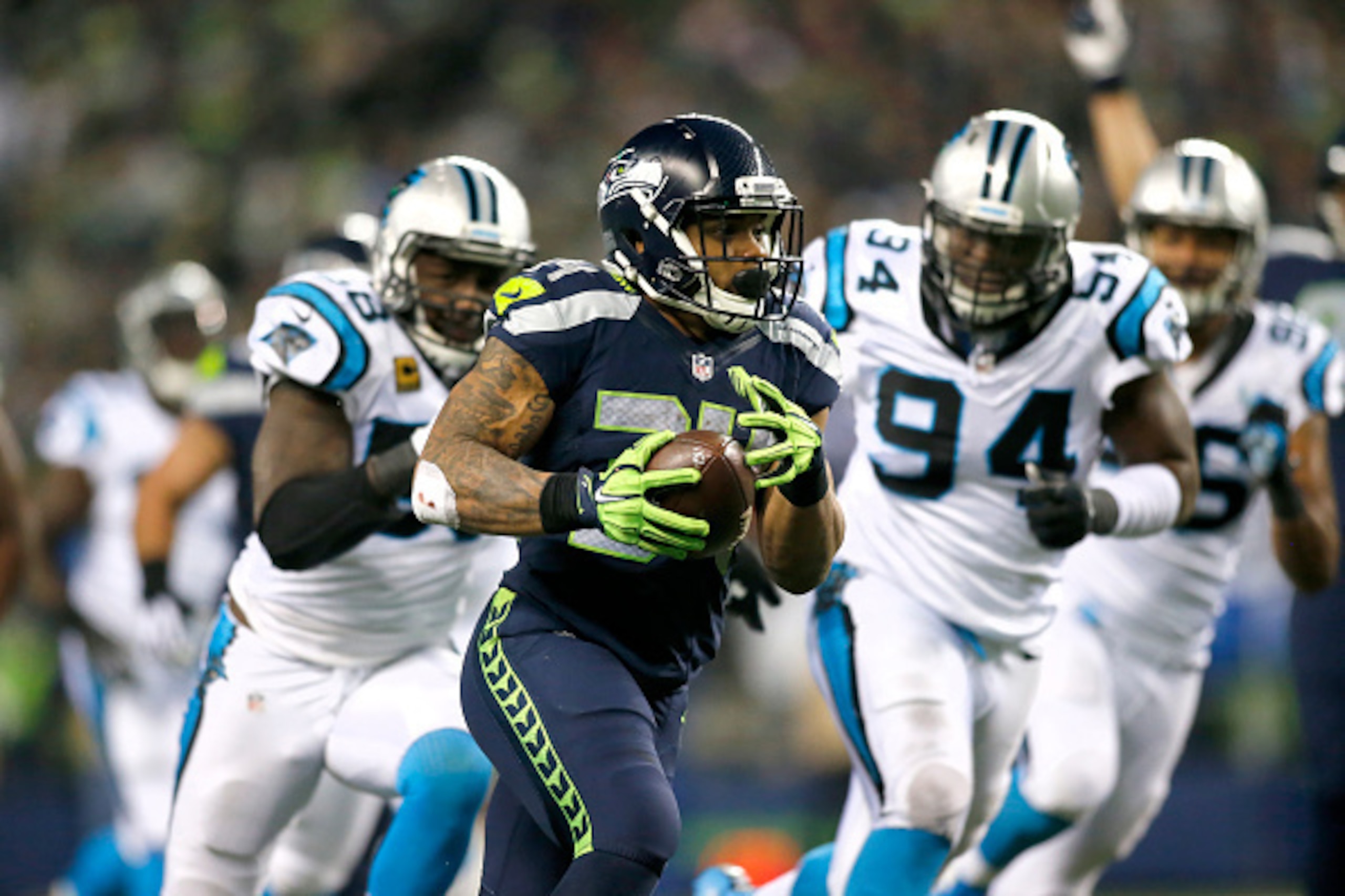 SEATTLE, WA - DECEMBER 04:  Running back Thomas Rawls #34 of the Seattle Seahawks rushes against the Carolina Panthers at CenturyLink Field on December 4, 2016 in Seattle, Washington.  (Photo by Jonathan Ferrey/Getty Images)