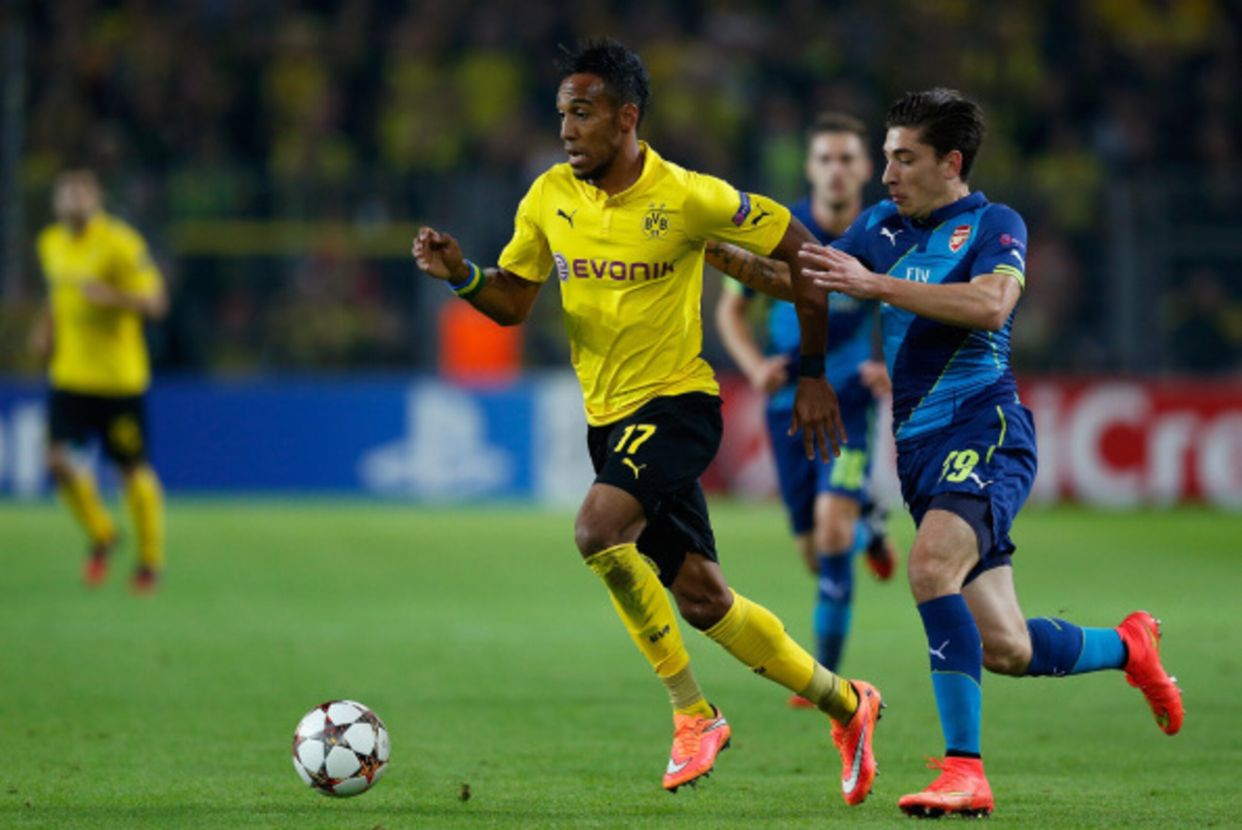 DORTMUND, GERMANY - SEPTEMBER 16: Hector Bellerin (R) of Arsenal challenges Pierre-Emerick Aubameyang (C) of Borussia Dortmund during the UEFA Champions League Group D match between Borussia Dortmund and Arsenal at Signal Iduna Park on September 16, 2014 