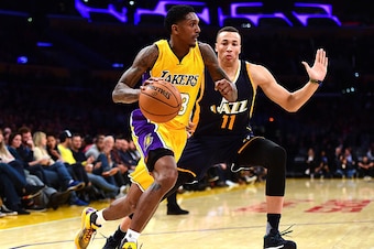 LOS ANGELES, CA - DECEMBER 05:  Louis Williams #23 of the Los Angeles Lakers dribbles against Dante Exum #11 of the Utah Jazz during the first half at Staples Center on December 5, 2016 in Los Angeles, California.  NOTE TO USER: User expressly acknowledge