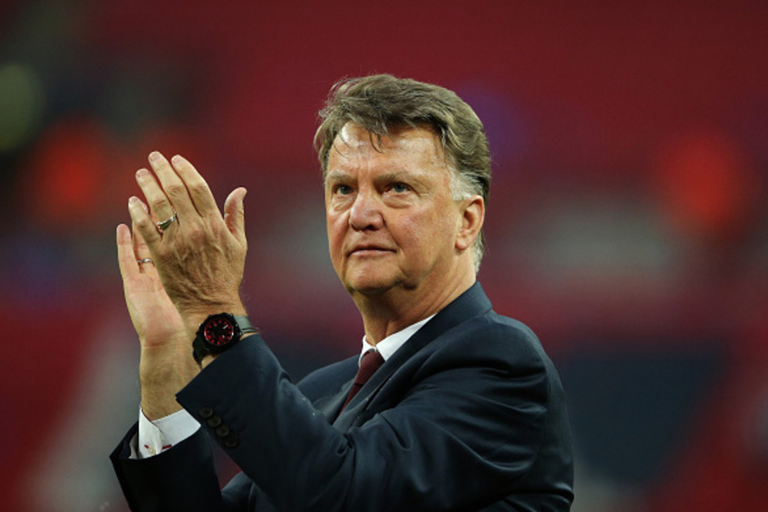 LONDON, ENGLAND - MAY 21: LONDON, ENGLAND - MAY 21: Louis van Gaal Manager / head coach of Manchester United watches his players celebrate victory after The Emirates FA Cup final match between Manchester United and Crystal Palace at Wembley Stadium on May