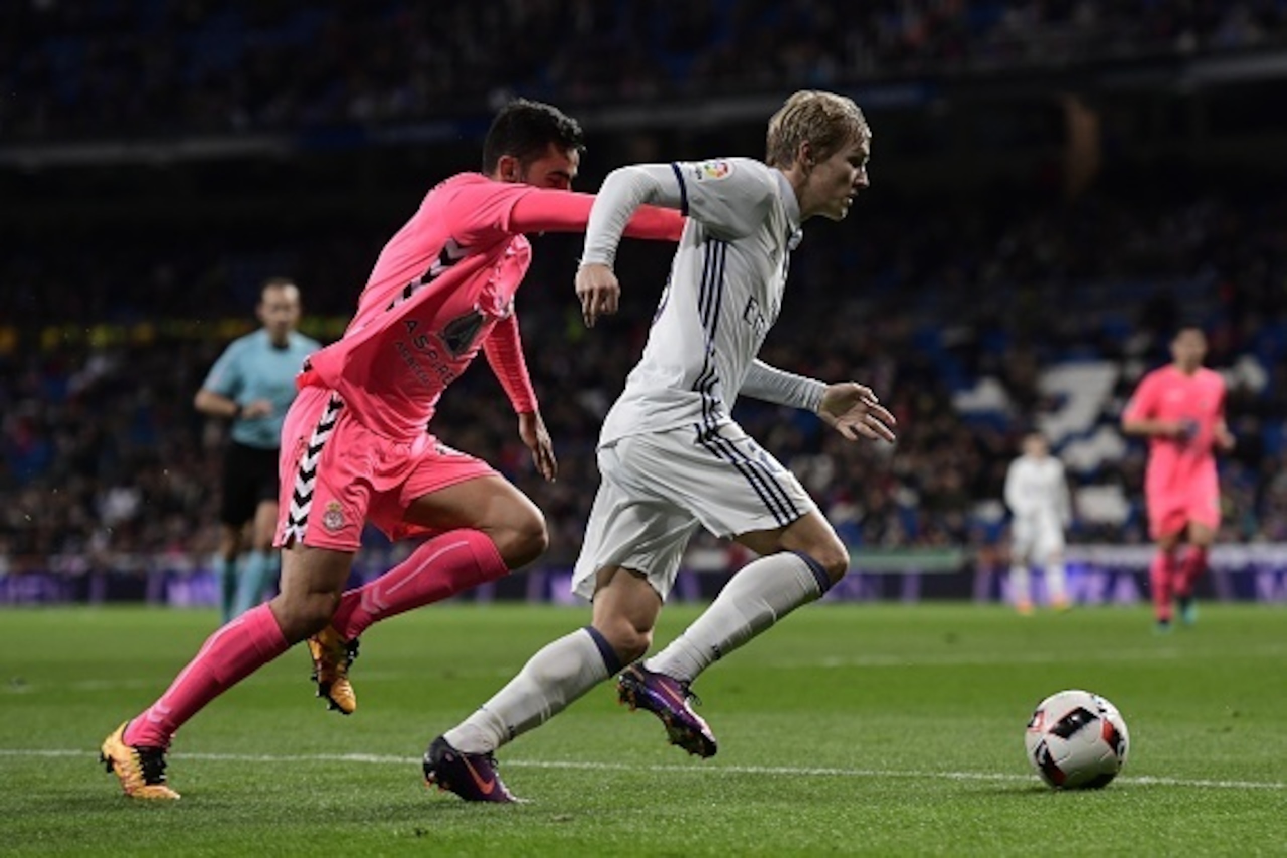 Real Madrid's Norwegian forward Martin Odegaard (R) vies with Cultural Leonesa's defender Victor Diaz  during the Spanish Copa del Rey (King's Cup) Round of 32 second leg football match Real Madrid CF vs Cultural y Deportiva Leonesa at the Santiago Bernab