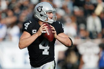 OAKLAND, CA - DECEMBER 04:  Derek Carr #4 of the Oakland Raiders looks to pass against the Buffalo Bills during their NFL game at Oakland Alameda Coliseum on December 4, 2016 in Oakland, California.  (Photo by Brian Bahr/Getty Images)