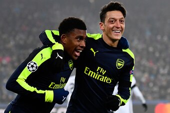 Arsenal's Nigerian forward Alex Iwobi (L) celebrates after scoring a goal with his teammate Arsenal's German midfielder Mesut Ozil during the UEFA Champions league Group A football match between FC Basel 1893 and Arsenal FC on December 6, 2016 at the St J