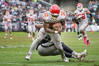 OAKLAND, CA - OCTOBER 16:  Running back Spencer Ware #32 the Kansas City Chiefs takes a short pass for 30 yards to the six yard line before getting caught by linebacker Cory James #57 of the Oakland Raiders in the third quarter on October 16, 2016 at Oakl