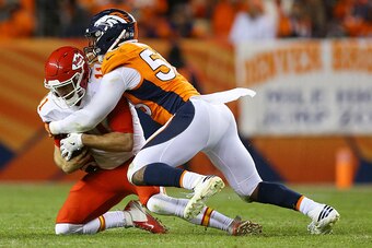 DENVER, CO - NOVEMBER 27:  Quarterback Alex Smith #11 of the Kansas City Chiefs is tackled by outside linebacker Von Miller #58 of the Denver Broncos in the fourth quarter of the game at Sports Authority Field at Mile High on November 27, 2016 in Denver, 