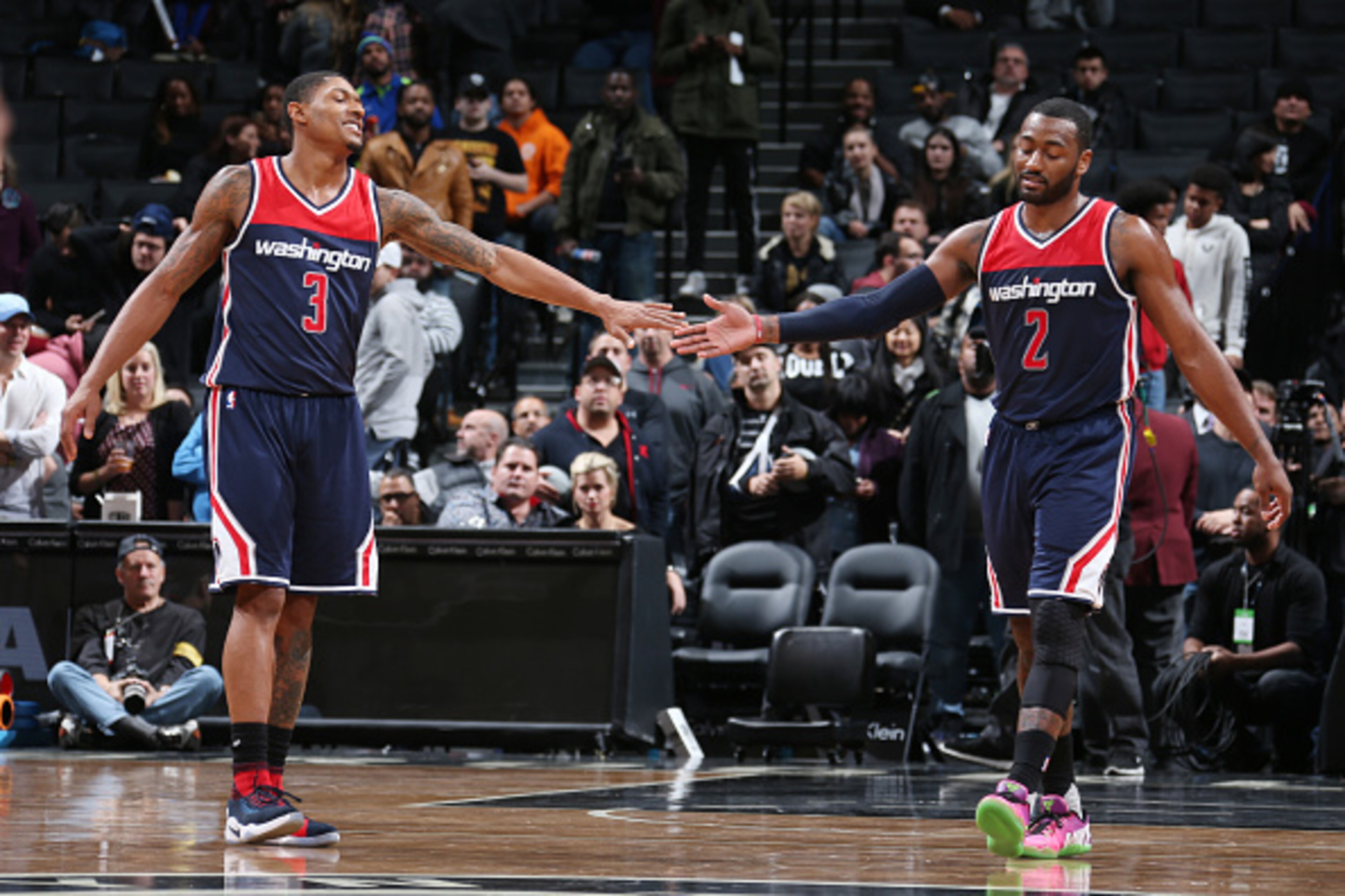BROOKLYN, NY - DECEMBER 5:  Bradley Beal #3 and John Wall #2 of the Washington Wizards celebrate a win against the Brooklyn Nets on December 5, 2016 at Barclays Center in Brooklyn, New York. NOTE TO USER: User expressly acknowledges and agrees that, by do