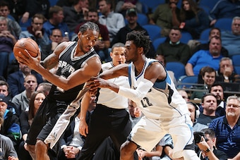 MINNEAPOLIS, MN - DECEMBER 6:  Kawhi Leonard #2 of the San Antonio Spurs handles the ball against Andrew Wiggins #22 of the Minnesota Timberwolves during a game on December 6, 2016 at the Target Center in Minneapolis, Minnesota. NOTE TO USER: User express