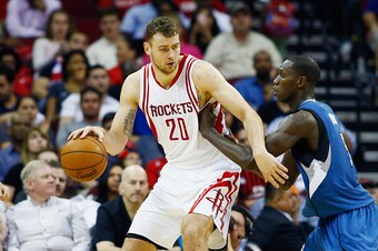 HOUSTON, TX - MARCH 18:  Donatas Motiejunas #20 of the Houston Rockets drives with the basketball against Gorgui Dieng #5 of the Minnesota Timberwolves during their game at the Toyota Center on March 18, 2016 in Houston, Texas.  NOTE TO USER: User express