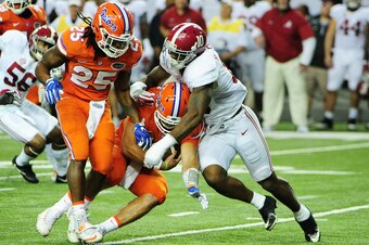ATLANTA, GA - DECEMBER 03:  Austin Appleby #12 of the Florida Gators is sacked by Reuben Foster #10 of the Alabama Crimson Tide in the first quarter during the SEC Championship game at the Georgia Dome on December 3, 2016 in Atlanta, Georgia.  (Photo by S