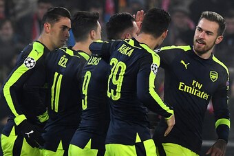Arsenal's players celebrate after Arsenal's Spanish forward Lucas Perez (3rdL) scored a goal during the UEFA Champions league Group A football match between FC Basel 1893 and Arsenal FC on December 6, 2016 at the St Jakob Park stadium in Basel. / AFP / Pa