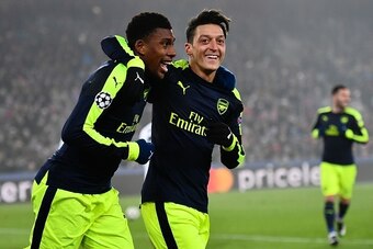 Arsenal's Nigerian forward Alex Iwobi (L) celebrates after scoring a goal with his teammate Arsenal's German midfielder Mesut Ozil during the UEFA Champions league Group A football match between FC Basel 1893 and Arsenal FC on December 6, 2016 at the St J