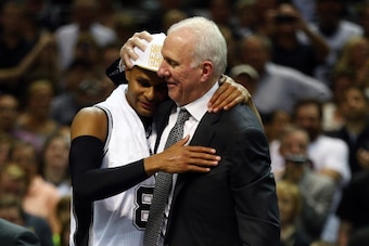 SAN ANTONIO, TX - JUNE 15: Gregg Popovich celebrates with Patty Mills #8 of the San Antonio Spurs after defeating the Miami Heat in Game Five of the 2014 NBA Finals at the AT&T Center on June 15, 2014 in San Antonio, Texas. NOTE TO USER: User expressly ac