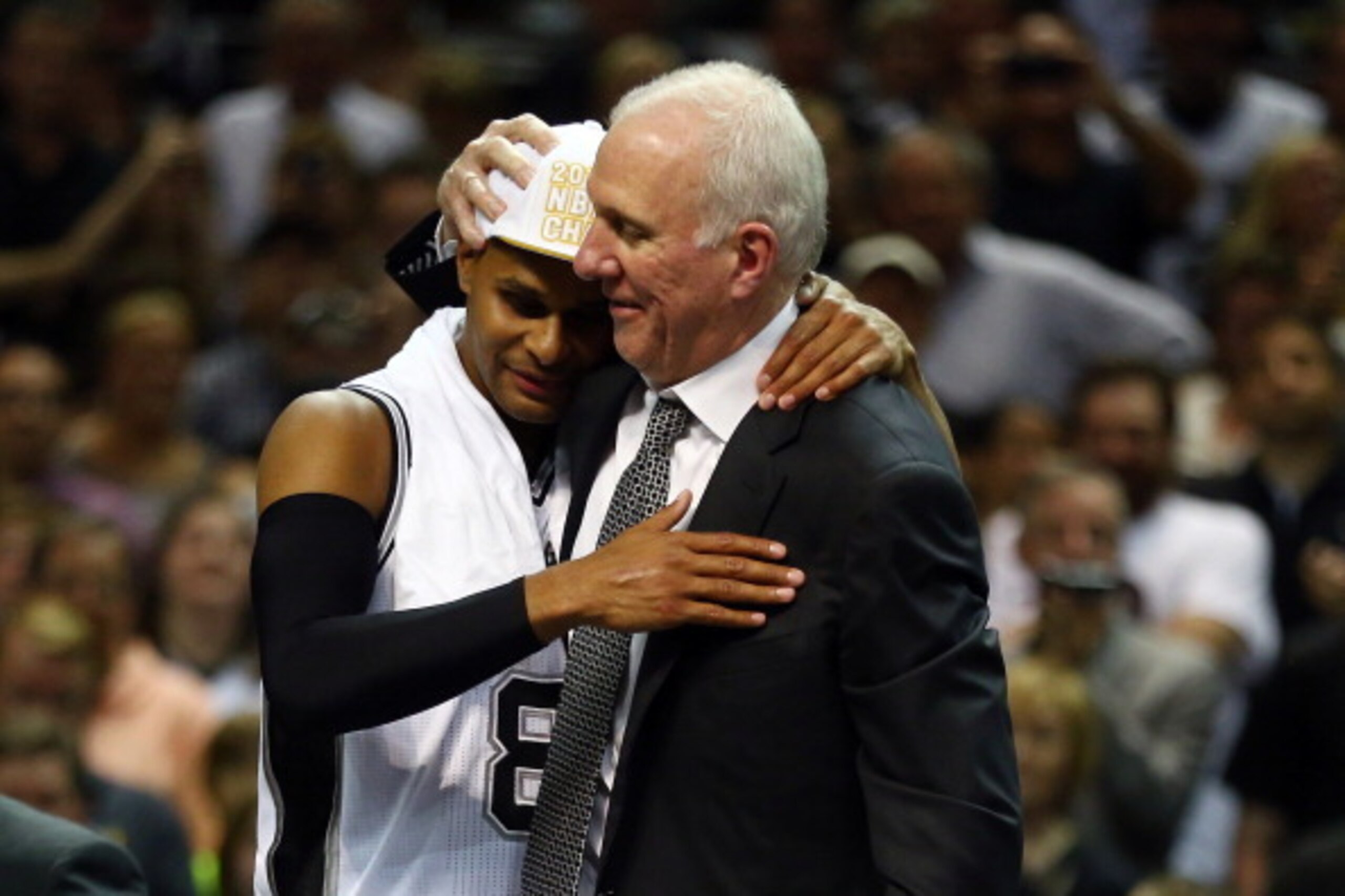 SAN ANTONIO, TX - JUNE 15: Gregg Popovich celebrates with Patty Mills #8 of the San Antonio Spurs after defeating the Miami Heat in Game Five of the 2014 NBA Finals at the AT&T Center on June 15, 2014 in San Antonio, Texas. NOTE TO USER: User expressly ac