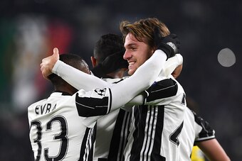 TURIN, ITALY - DECEMBER 07:  Daniele Rugani (R) of Juventus celebrates a goal with team mate Patrice Evra during the UEFA Champions League Group H match between Juventus and GNK Dinamo Zagreb at Juventus Stadium on December 7, 2016 in Turin.  (Photo by Va