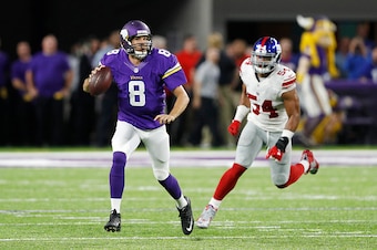 MINNEAPOLIS, MN - OCTOBER 03: Sam Bradford #8 of the Minnesota Vikings looks to pass while being chased by Olivier Vernon #54 of the New York Giants during the game at U.S. Bank Stadium on October 3, 2016 in Minneapolis, Minnesota. The Vikings defeated th