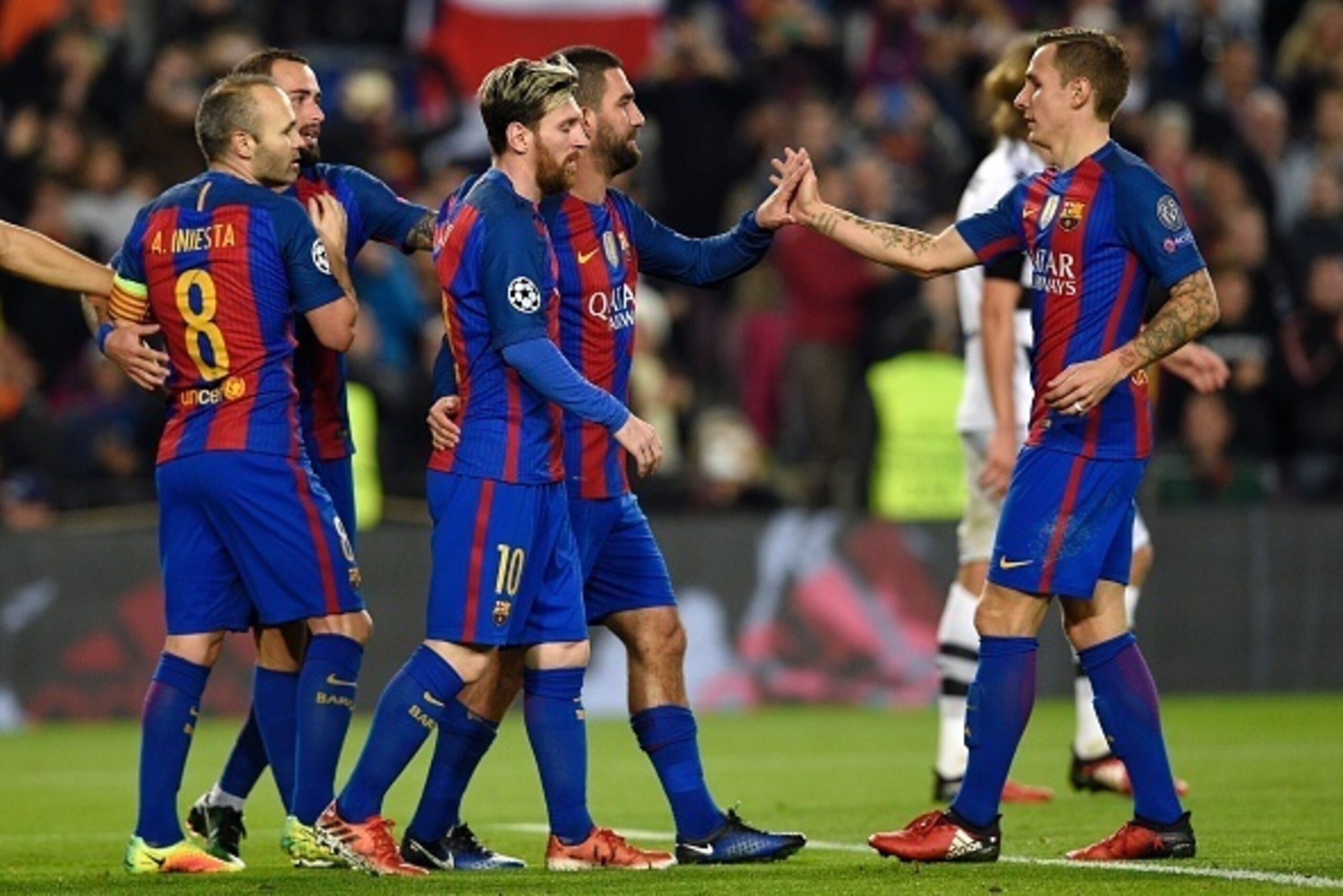 Barcelona's Turkish forward Arda Turan (C) celebrates with Barcelona's French defender Lucas Digne (R) and Barcelona's Argentinian forward Lionel Messi after scoring during the UEFA Champions League Group C football match FC Barcelona vs Borussia Moenchen