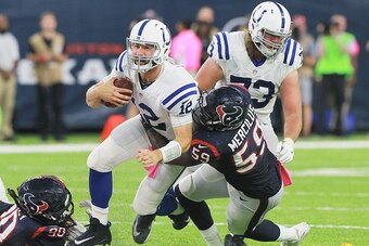 HOUSTON, TX - OCTOBER 16: Andrew Luck #12 of the Indianapolis Colts is sacked by Whitney Merciless #59 of the Houston Texans and Jadeveon Clowney #90 at NRG Stadium on October 16, 2016 in Houston, Texas.  (Photo by Bob Levey/Getty Images)